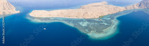 The arid islands found within Komodo National Park, Indonesia, are surrounded by lush coral reefs. This is a popular destination for scuba divers and snorkelers due to its high marine biodiversity.