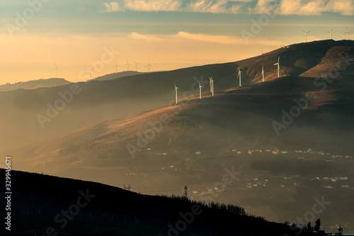 Landscape of Marão in Portugal, at sunset on a winter afternoon, with the wind farm highlighted by sunlight. View from the Boa Vista viewpoint near Lamego photo