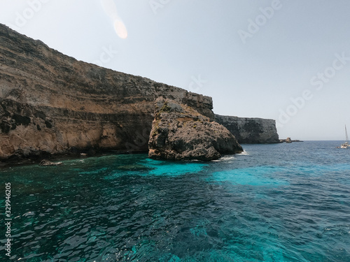 Rocks on the island of Malta  surrounding them a clear water. The island of Malta  Gozo and Comino have beautiful beaches.