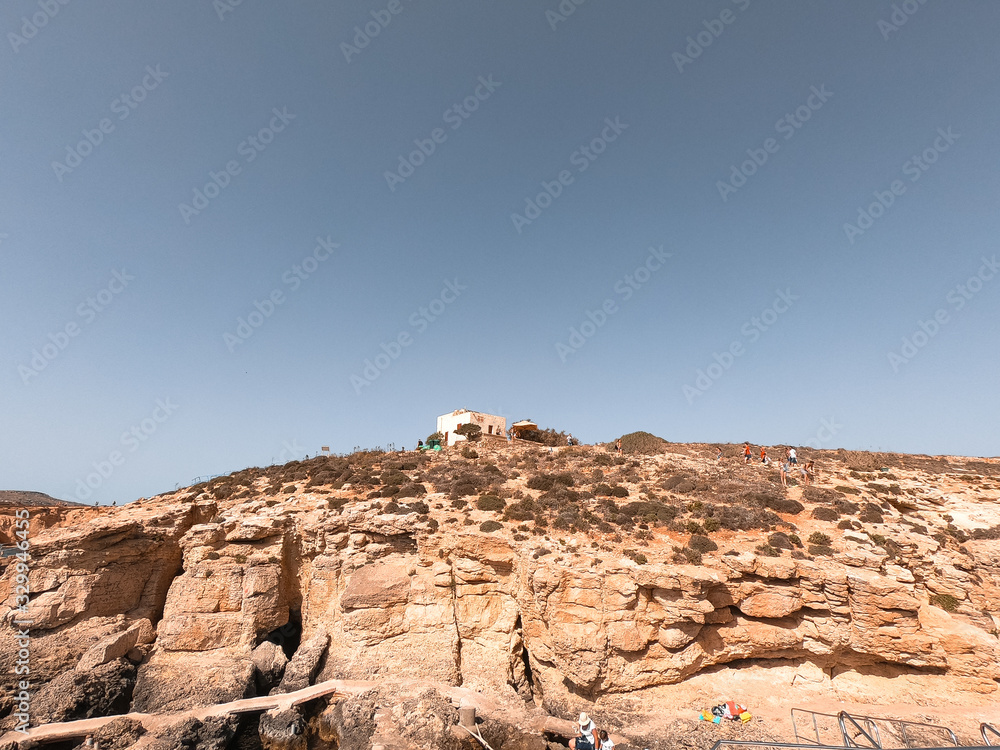 Residents and tourists enjoy at Comino Beach, Malta. One of the most visited beaches in Malta, where most people enjoy the weather, beaches and attractions. Residents and tourists enjoy at Comino Beach, Malta. One of the most visited beaches in Malta, where most people enjoy the weather, beaches and attractions.