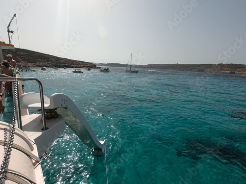 Residents and tourists enjoy at Comino Beach, Malta. One of the most visited beaches in Malta, where most people enjoy the weather, beaches and attractions.