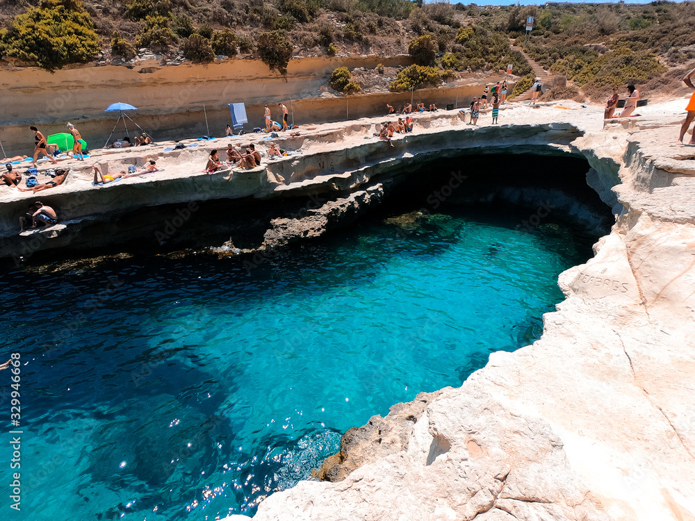 People enjoying the natural pool of Malta.