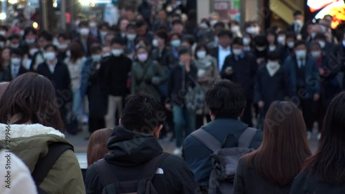 Wallpaper Mural TOKYO, JAPAN - MARCH 2020 : Crowd of people at the street near Shinjuku station in rush hour. Commuters and tourists wearing surgical mask to protect from Coronavirus(COVID-19) or cold. Slow motion. Torontodigital.ca
