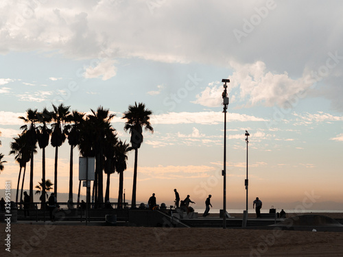 Santa Monica, United States - November 25, 2019: Skateboard park in Venice beach with people skating next to the beach. The best known skate park.