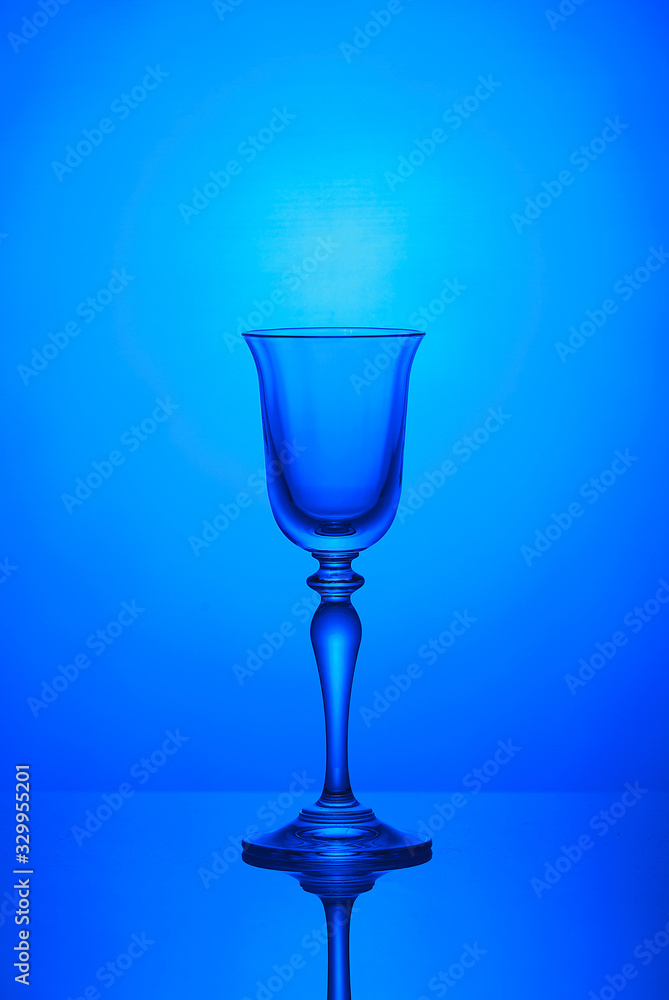 Empty wine glass on a blue background Empty wine glass on a blue background