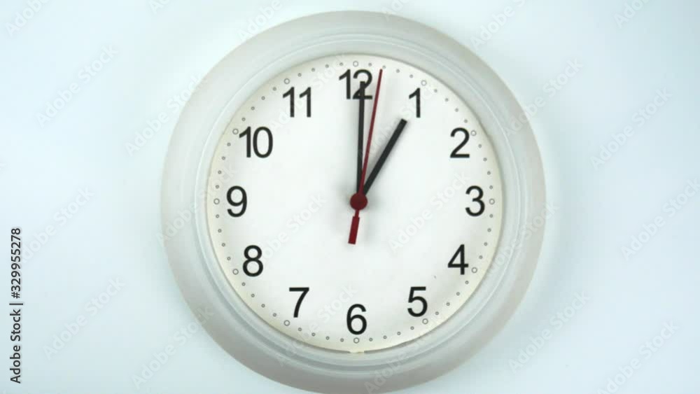 White wall clock on white background, face beginning of time 01.00 am or pm, Clock minute walk slowly, Time concept. White wall clock on white background, face beginning of time 01.00 am or pm, Clock minute walk slowly, Time concept.
