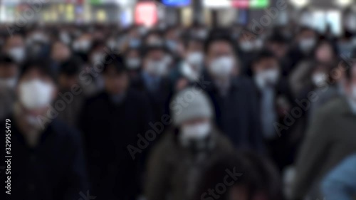 Wallpaper Mural TOKYO, JAPAN - MARCH 2020 : Crowd of people walking at Shinagawa station in morning rush hour. Commuters going to work. People wearing mask to protect from Coronavirus(COVID-19). Blurred slow motion. Torontodigital.ca