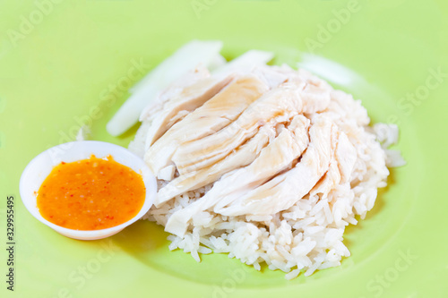 Traditional Asian Chinese Street Food: Khao Man Kai (Kao Man Gai) is Hainanese chicken rice, steamed chicken meat and white rice. Khao Man is cooked rice in an oily or coconut sauce, Kai is chicken.