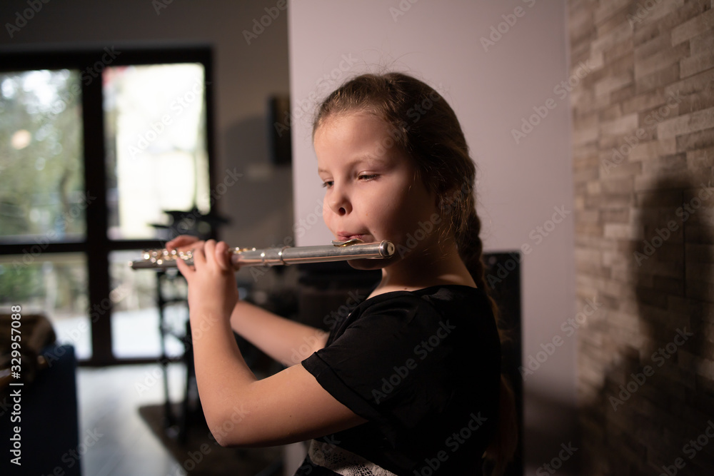 little girl playing the flute at home Stock Photo Adobe Stock