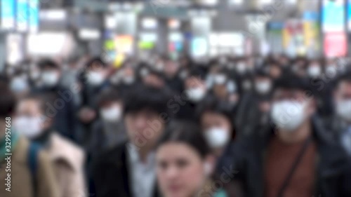 Wallpaper Mural TOKYO, JAPAN - MARCH 2020 : Crowd of people walking at Shinagawa station in morning rush hour. Commuters going to work. People wearing mask to protect from Coronavirus(COVID-19). Blurred slow motion. Torontodigital.ca