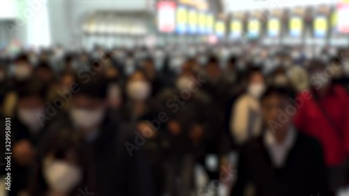 Wallpaper Mural TOKYO, JAPAN - MARCH 2020 : Crowd of people walking at Shinagawa station in morning rush hour. Commuters going to work. People wearing mask to protect from Coronavirus(COVID-19). Blurred slow motion. Torontodigital.ca