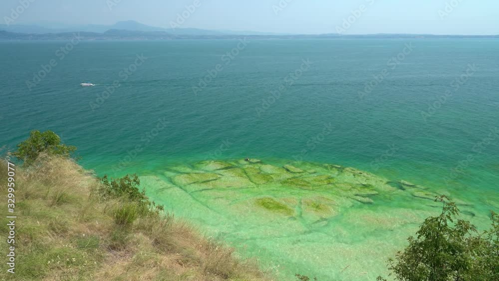 Jamaica Beach at Sirmione, on Lake Garda, renowed for its beautiful emerald water. Province of Brescia, Lombardy, Italy. Jamaica Beach at Sirmione, on Lake Garda, renowed for its beautiful emerald water. Province of Brescia, Lombardy, Italy.