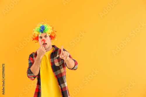 Man in funny disguise on color background. April fools' day celebration