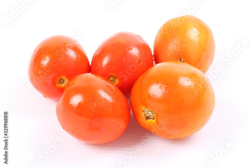 Pile of fresh tomatoes isolated on white background