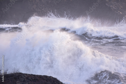 Powerful waves of the North Atlantic Ocean crash into the rocky shoreline of southern Iceland.