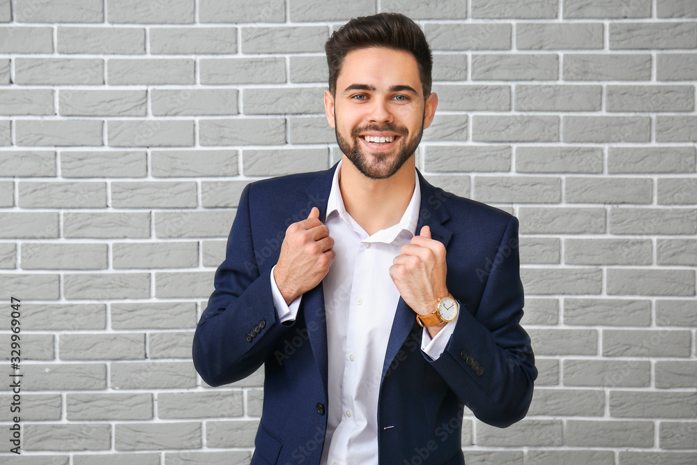 Portrait of handsome businessman on brick background Portrait of handsome businessman on brick background