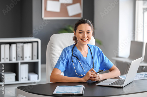 Young female doctor working in clinic photo