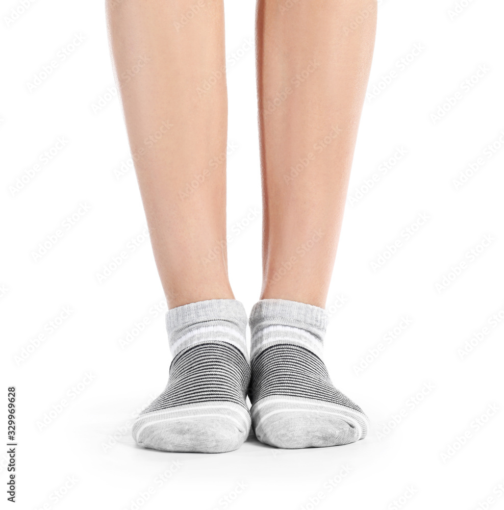 Legs of young woman in socks on white background