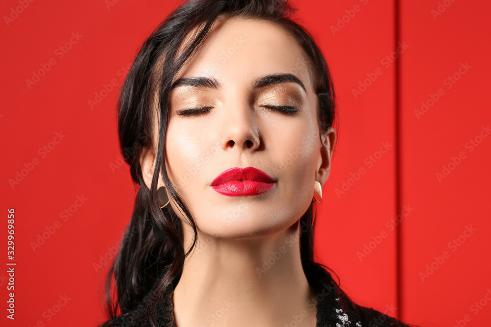 Fototapeta premium Young woman with beautiful makeup on color background