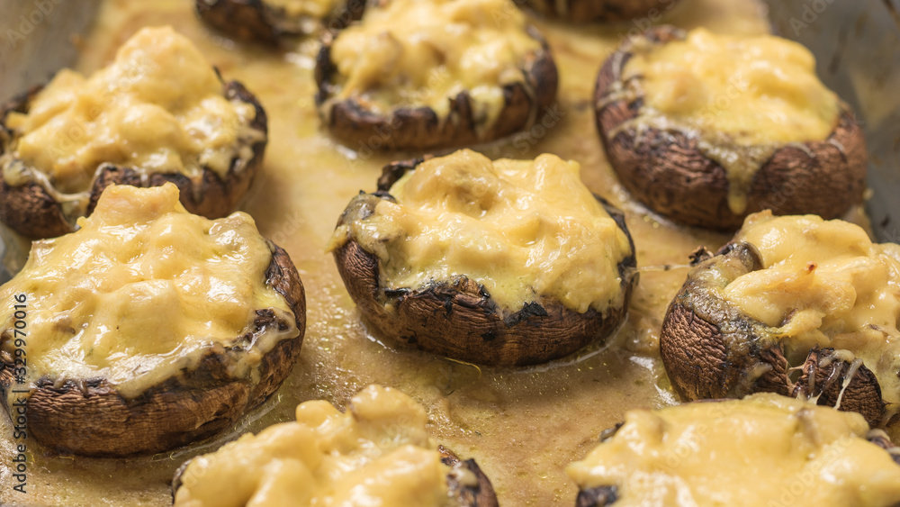 A glass pan filled with baked Royal mushrooms.