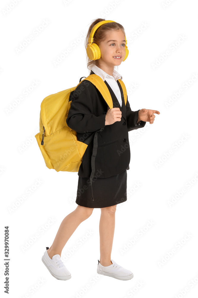 Cute little schoolgirl with headphones on white background Cute little schoolgirl with headphones on white background