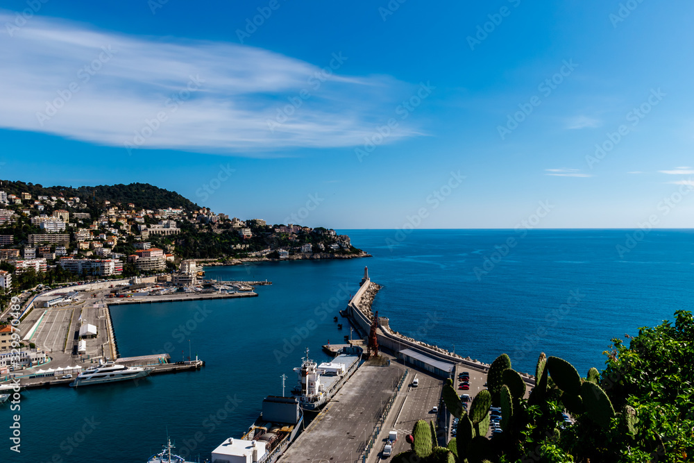 The panoramic view of the old port, the lighthouse and the Mediterranean Sea in Nice, France