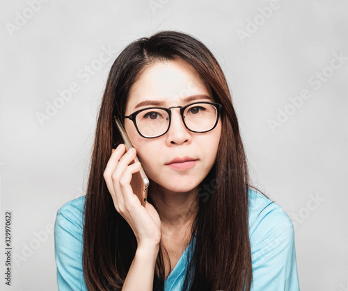 people make gesturing Young beautiful asian woman wore glasses and blue t-shirt , Show that Do not, stop, not accept, afraid, Don't like it. Don't come in and go out.