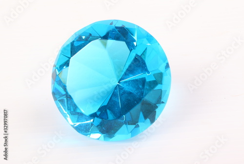 Blue diamond on white surface