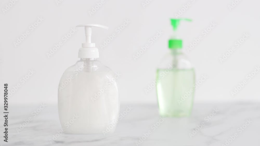 hygiene against viruses and bacteria, hand sanitizer and liquid soap bottle on marble bathroom and camera panning horizontally hygiene against viruses and bacteria, hand sanitizer and liquid soap bottle on marble bathroom and camera panning horizontally