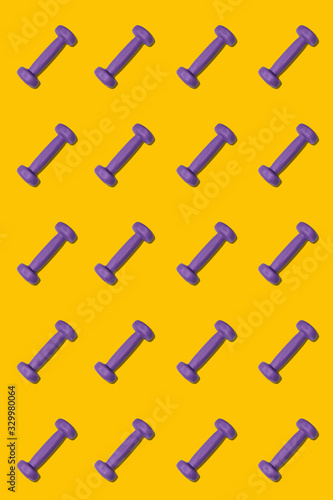 Dumbbell pattern, diagonal composition on a bright yellow background, sport concept © evafesenuk