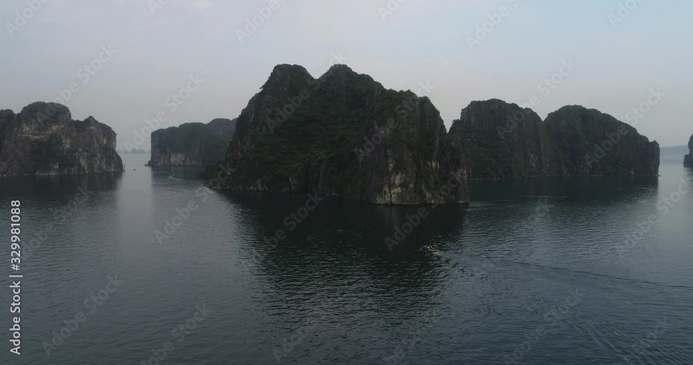 Aerial view of royalty high quality free stock footage over natural rocks green tops Halong bay, Ba Hang floating fishing village, sea blue azure water. Wild natural untouched seascape. Asia, Vietnam Aerial view of royalty high quality free stock footage over natural rocks green tops Halong bay, Ba Hang floating fishing village, sea blue azure water. Wild natural untouched seascape. Asia, Vietnam