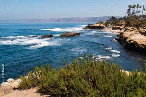 A view of people at La Jolla Cove from atop a cliff in La Jolla, California in San Diego County.  photo