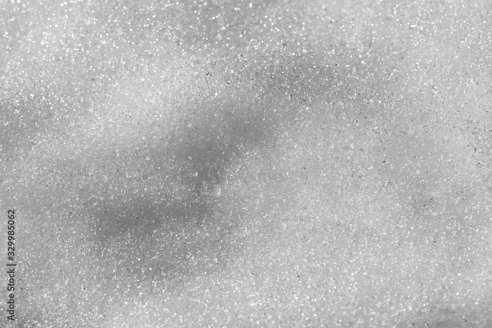 The surface of the melting snow closeup as a background. The surface of the melting snow closeup as a background.