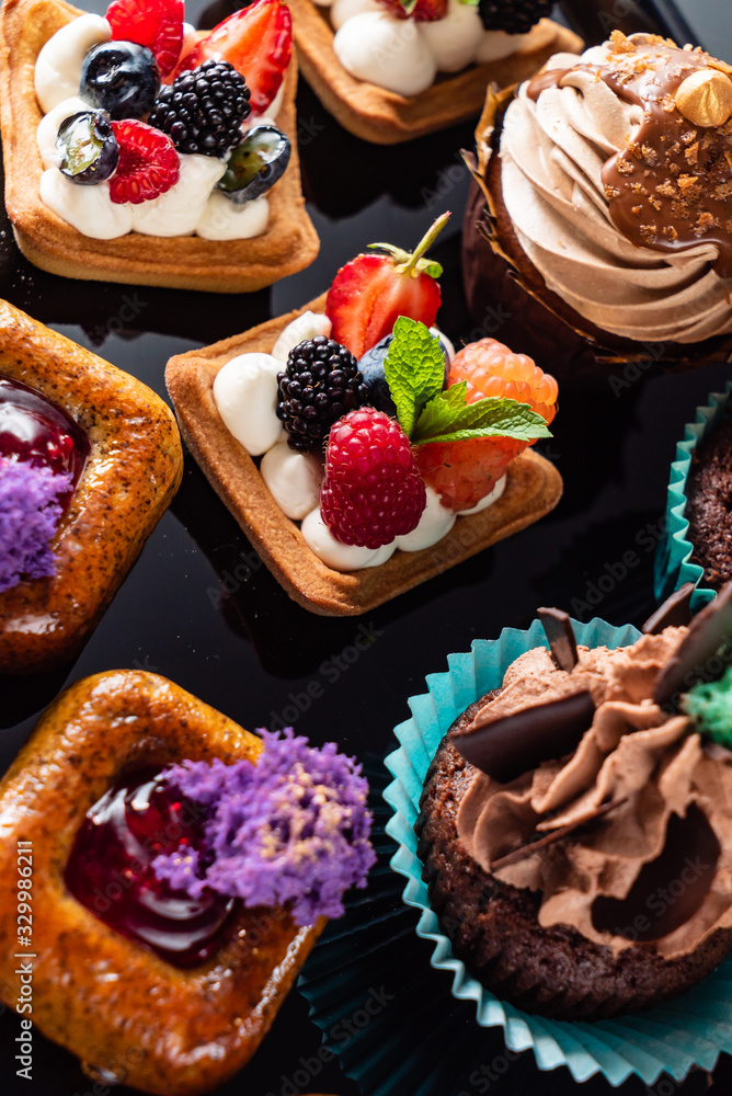 set of pastries on the black background set of pastries on the black background