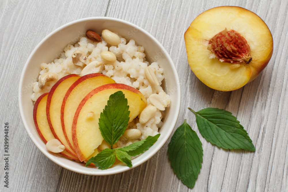 Sorghum salad with nuts and fresh peach on gray boards. Sorghum salad with nuts and fresh peach on gray boards.
