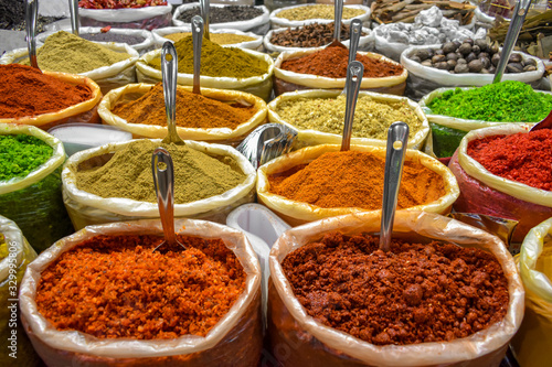 Fototapeta Naklejka Na Ścianę i Meble -  Colorful spices of many varieties stacked up for sale in traditional open air market of India. These spices are used as condiments, to flavor the food and is widely popular among foreign tourists.