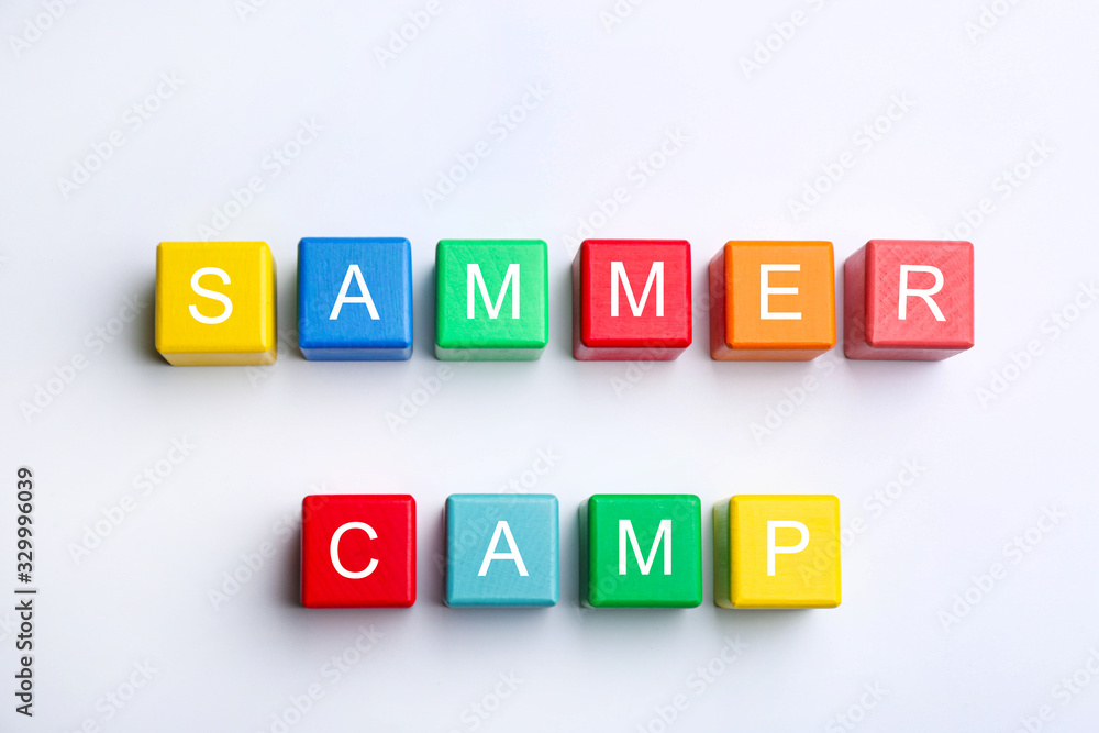 Colorful wooden cubes with phrase SUMMER CAMP on white background, top view Colorful wooden cubes with phrase SUMMER CAMP on white background, top view