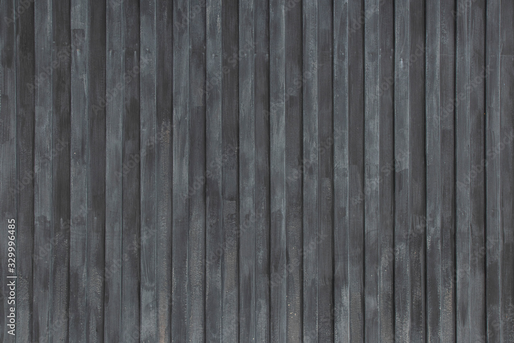 Naklejka premium Wooden fence painted with black on the tea plantations,