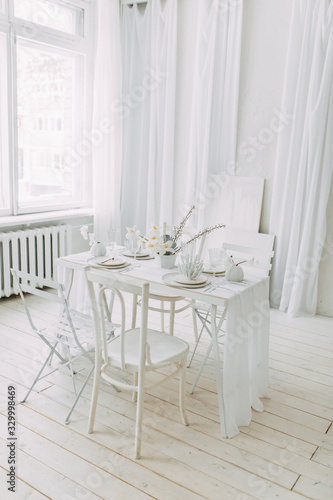  Coral and white printing in concept. Light interior of the photo Studio. White wedding table decor. © pavelvozmischev