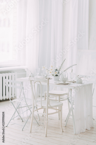  Coral and white printing in concept. Light interior of the photo Studio. White wedding table decor.