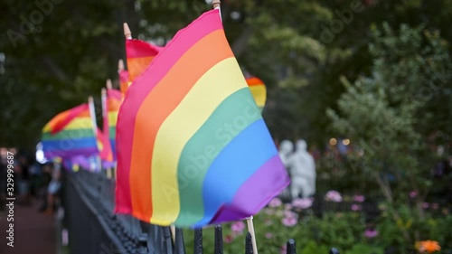 LGBTQ flags on the Christopher Park fence during 50th anniversary of the Stonewall riots, Greenwich Village NYC, day time photo