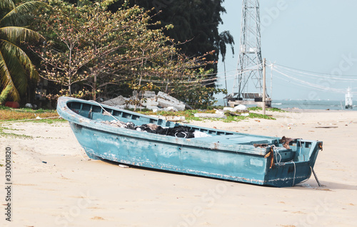 Old blue boat on the sandy shore