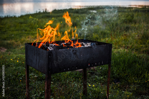 Fire on the grill, nature and grass