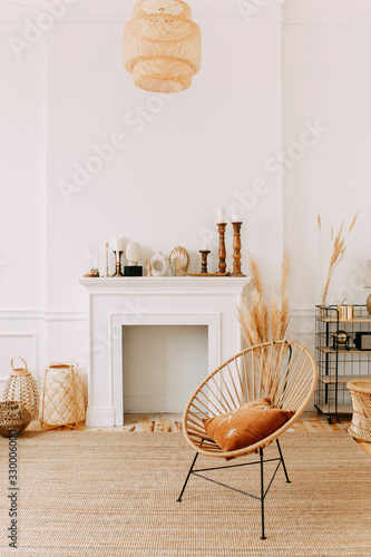 living room interior, fireplace against a white wall, armchair, modern design, photo studio, decorative elements, cute house, lifestyle