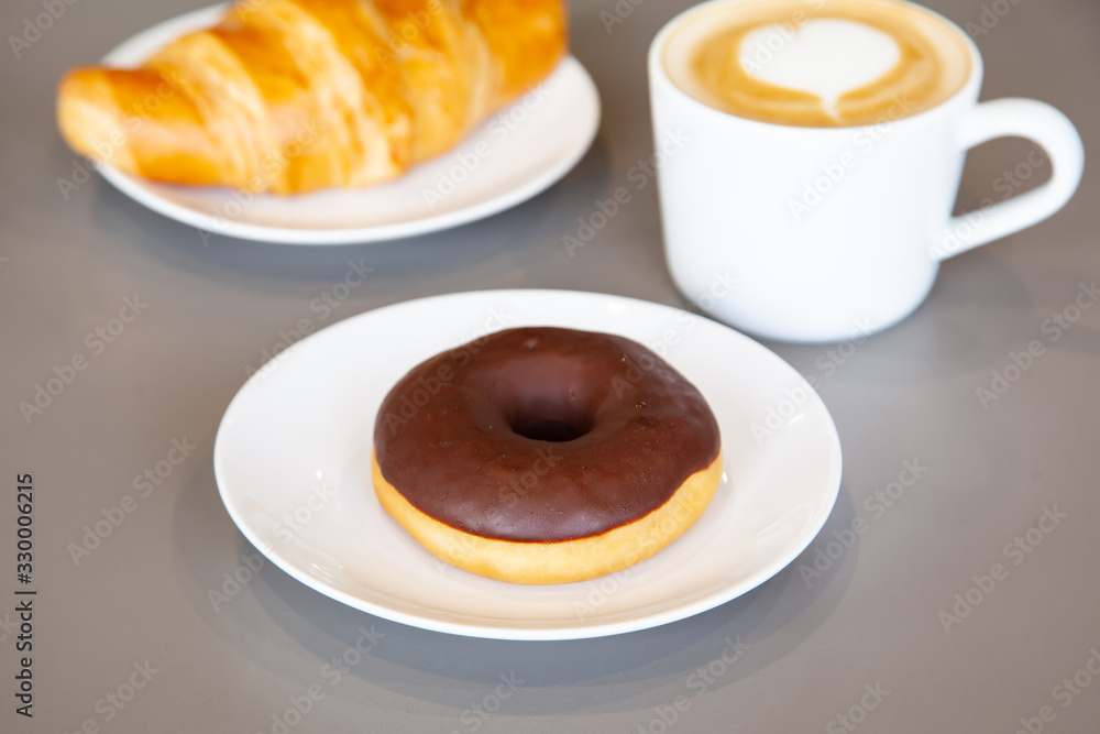 Delicious chocolate donut on white plate Delicious chocolate donut on white plate