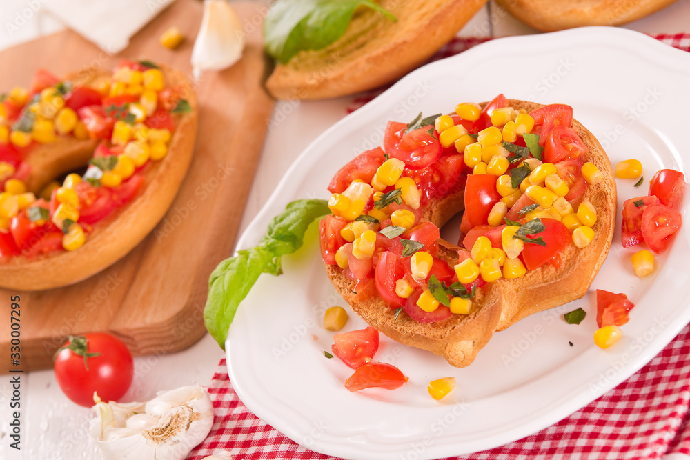 Friselle with tomatoes and mais. Friselle with tomatoes and mais.