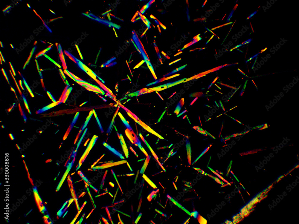 Crystal layer on microscope object glass, seen in polarized light. This causes random unforeseeable color effects. Crystal layer on microscope object glass, seen in polarized light. This causes random unforeseeable color effects.