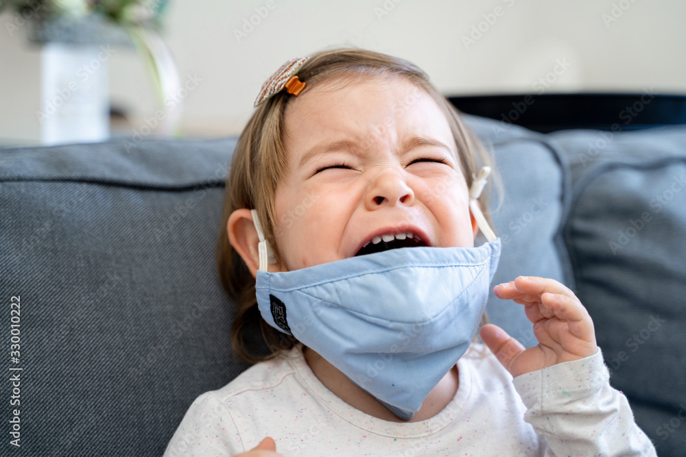 Toddler girl with medical mask on the face. Covid 2019 corona virus outbreak Toddler girl with medical mask on the face. Covid 2019 corona virus outbreak