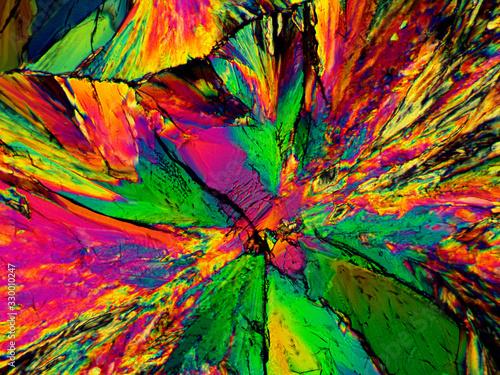 Crystal layer on microscope object glass, seen in polarized light. This causes random unforeseeable color effects.