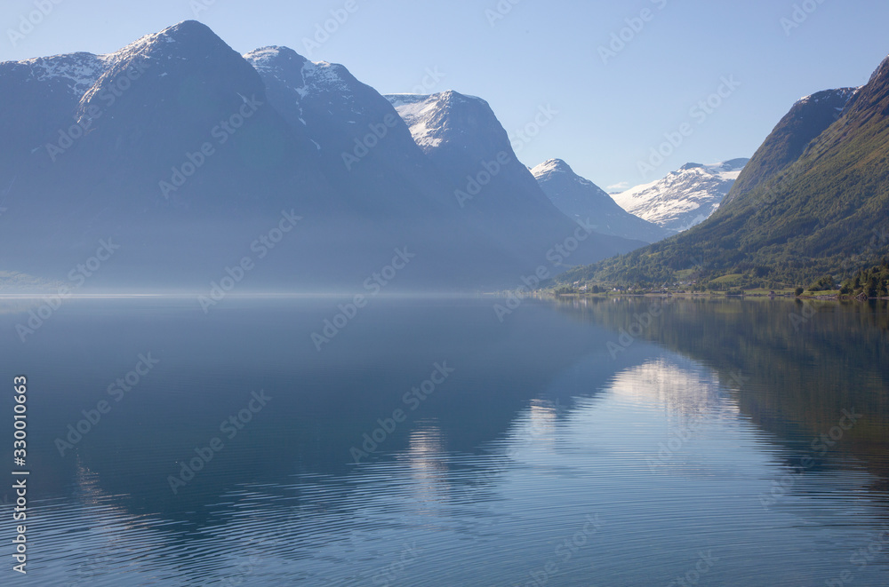 Traveling Norway along the fjords with beautiful reflections